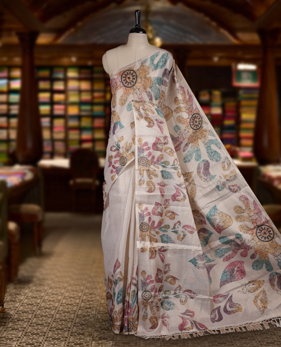 Beige colour Semi tissue saree adorned with Multi colour digital Leaf Design on the body and an elegant pallu & comes with a matching blouse piece