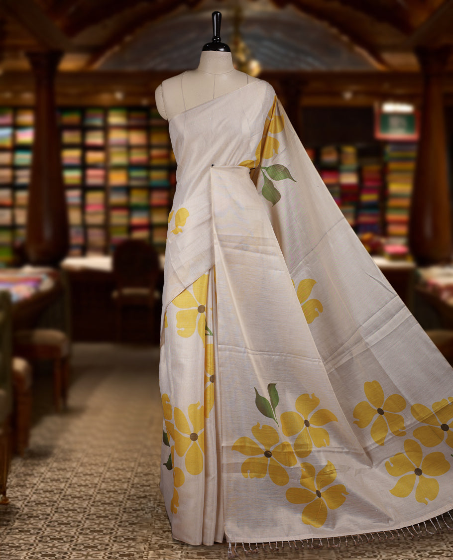 Beige colour Semi tissue saree adorned with Yellow colour digital Bold Floral Design on the body and an elegant pallu & comes with a matching blouse piece