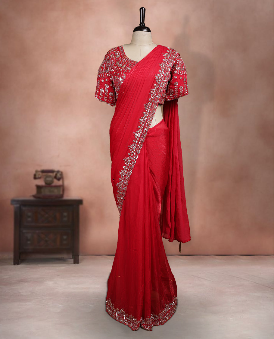Elegant Deep Red ready to wear saree adorned with rich silver zari and bead embroidery along the border and pallu, paired with a heavily embellished matching blouse for a grand festive look.