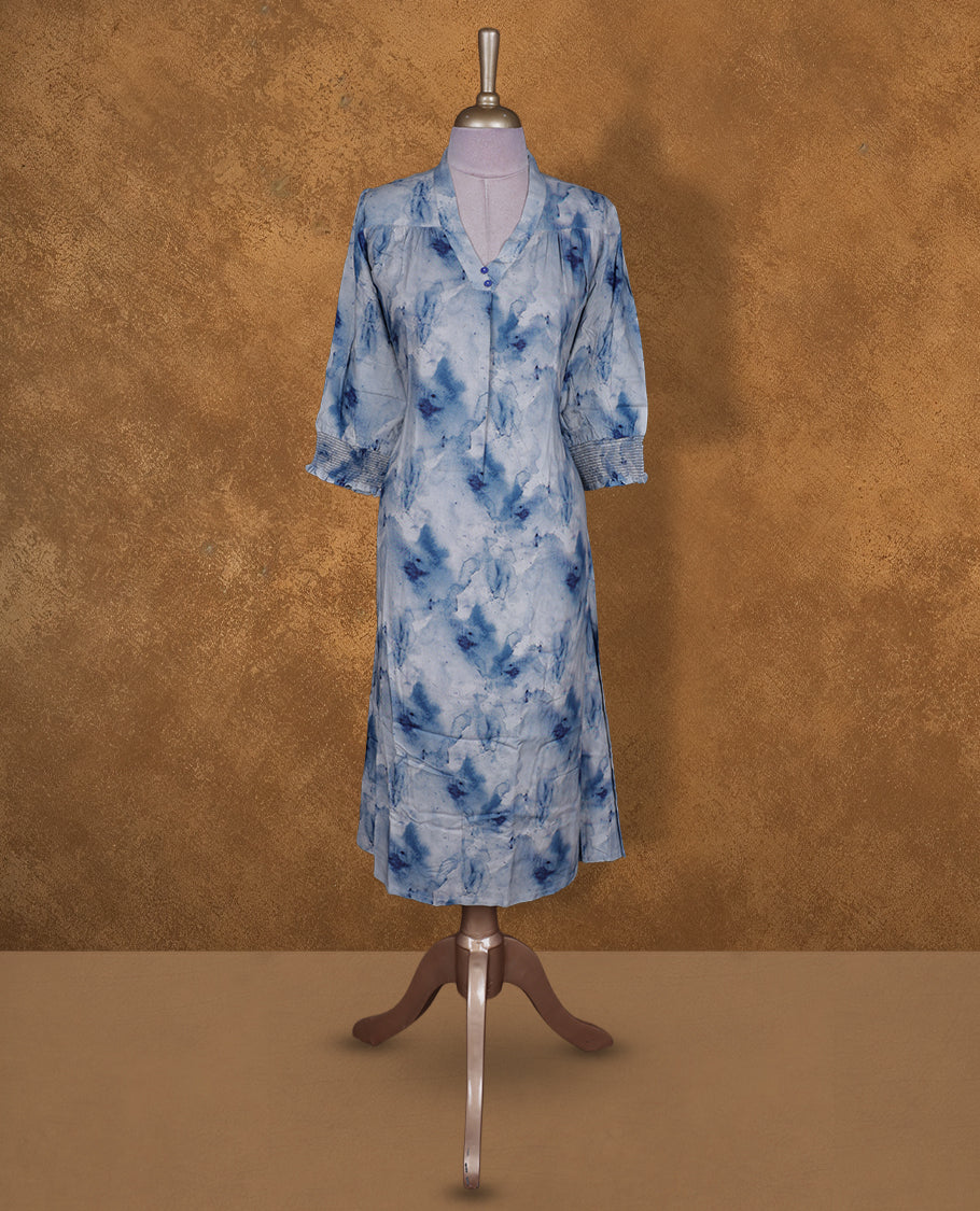 Light blue colour tie dye kurti BY VISMAY with darker blue floral accents, straight calf length silhouette, featuring a V notch neckline and three quarter sleeves with gathered cuffs.