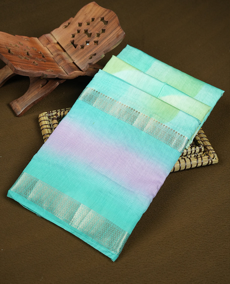 Turquoise and mint green colour mixed chanderi cotton saree with wavy ombre body, silver zari borders, lavender-pink gradient border accents, and matching turquoise blouse.