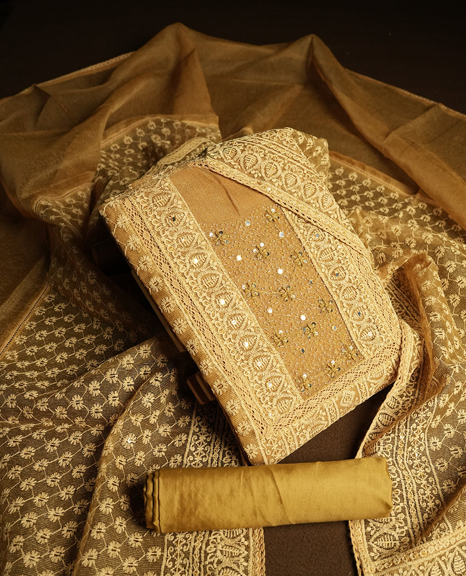 Golden Beige colour churidar material featuring intricate thread embroidery with mirror & cut beads work on the front panel, paired with an all over embroidered net dupatta and matching bottom.