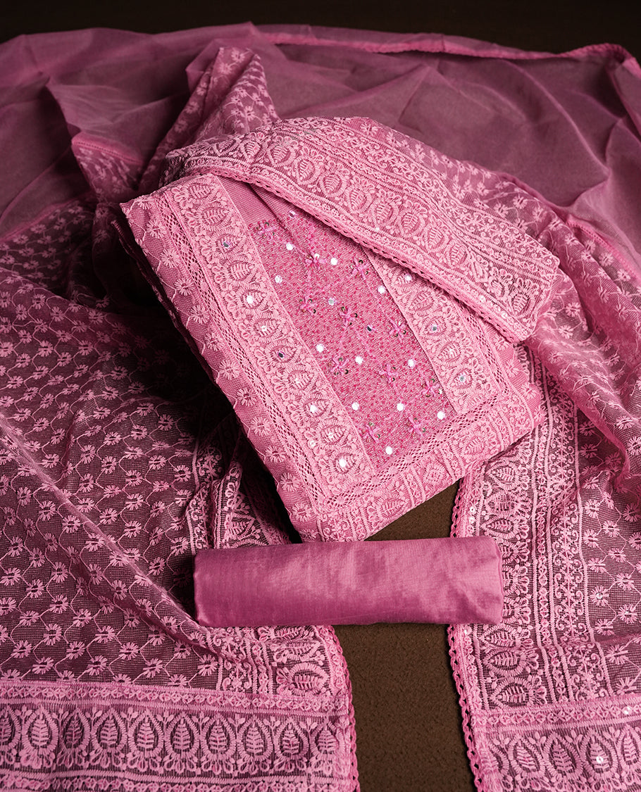 Soft Pink colour churidar material featuring intricate thread embroidery with mirror & cut beads work on the front panel, paired with an all over embroidered net dupatta and matching bottom.