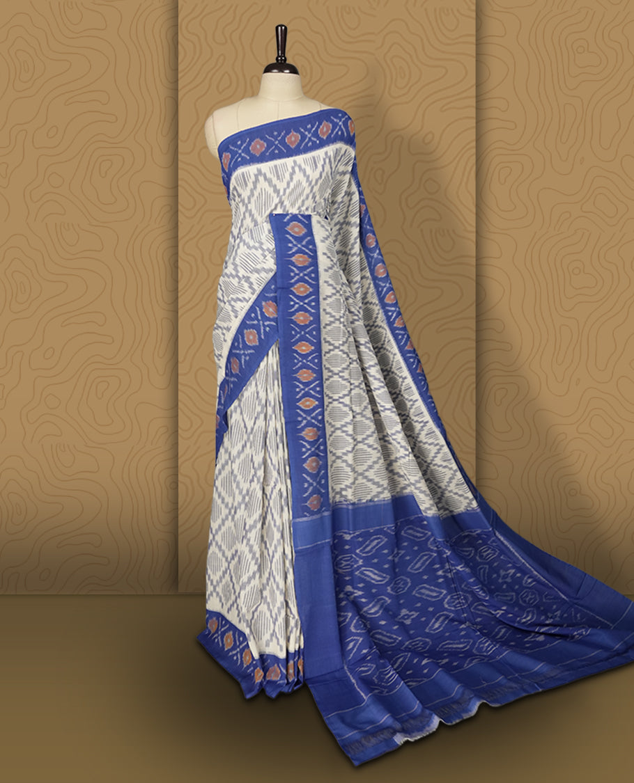Off white and blue colour Ikkat Pochampally saree featuring intricate geometric patterns on the body, complemented by a vibrant blue border with traditional motifs for an elegant look.