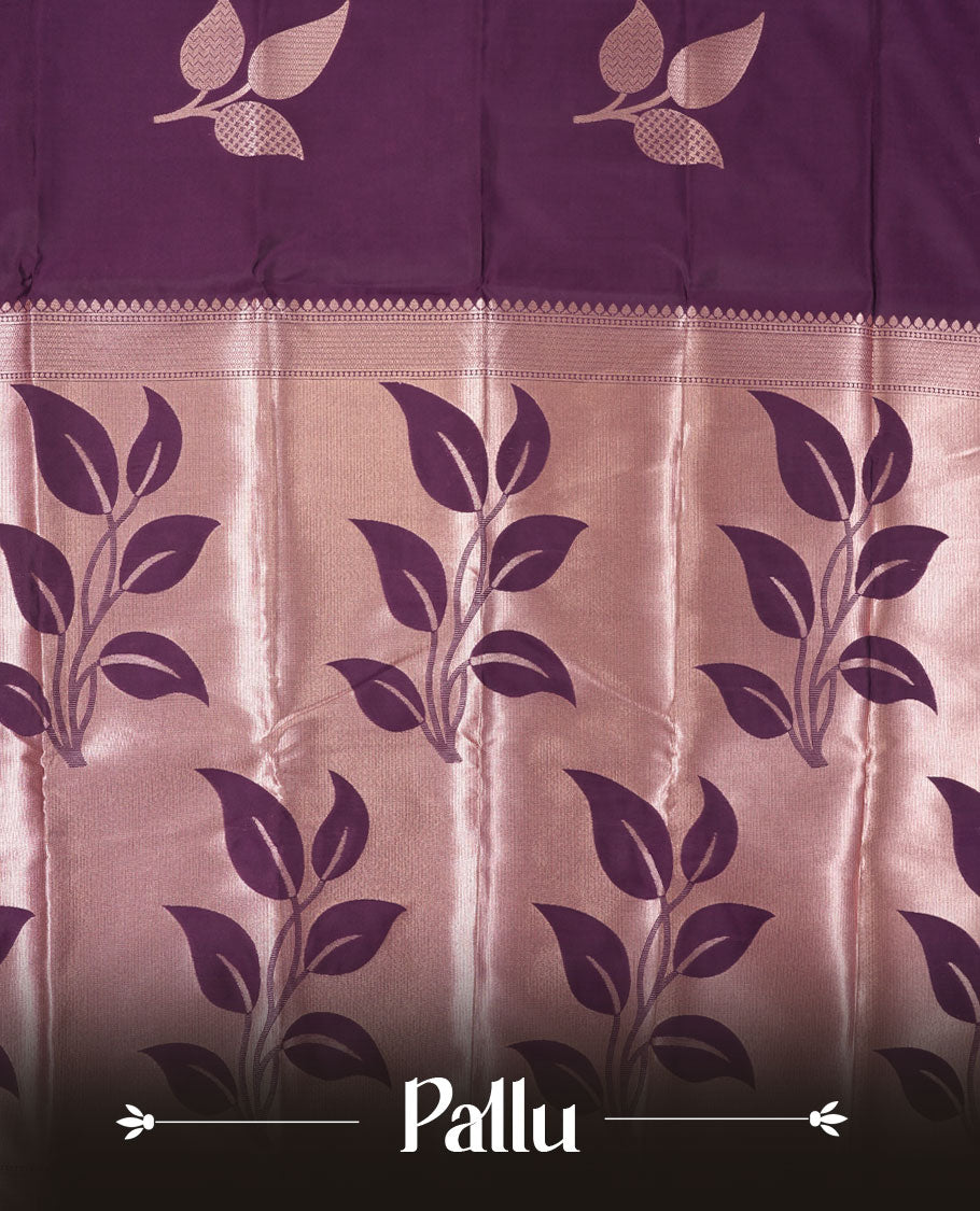 Dark purple colour semi silk saree adorned with elegant leaf motifs on the body, complemented by a shimmering golden zari-woven pallu and border, and paired with a matching blouse