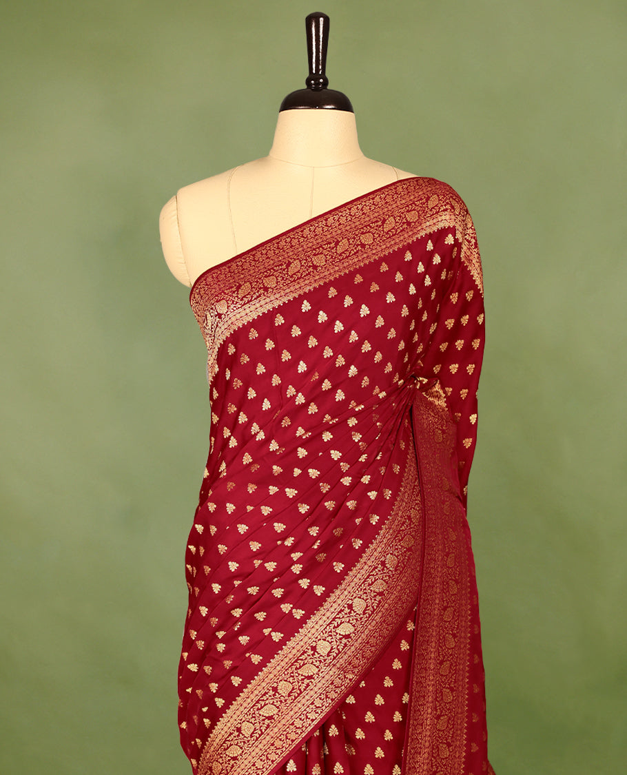 Chilli Red semi-Banaras satin crepe saree featuring traditional closely woven buttas on the body, complemented by an antique-style border and a matching self-coloured blouse.