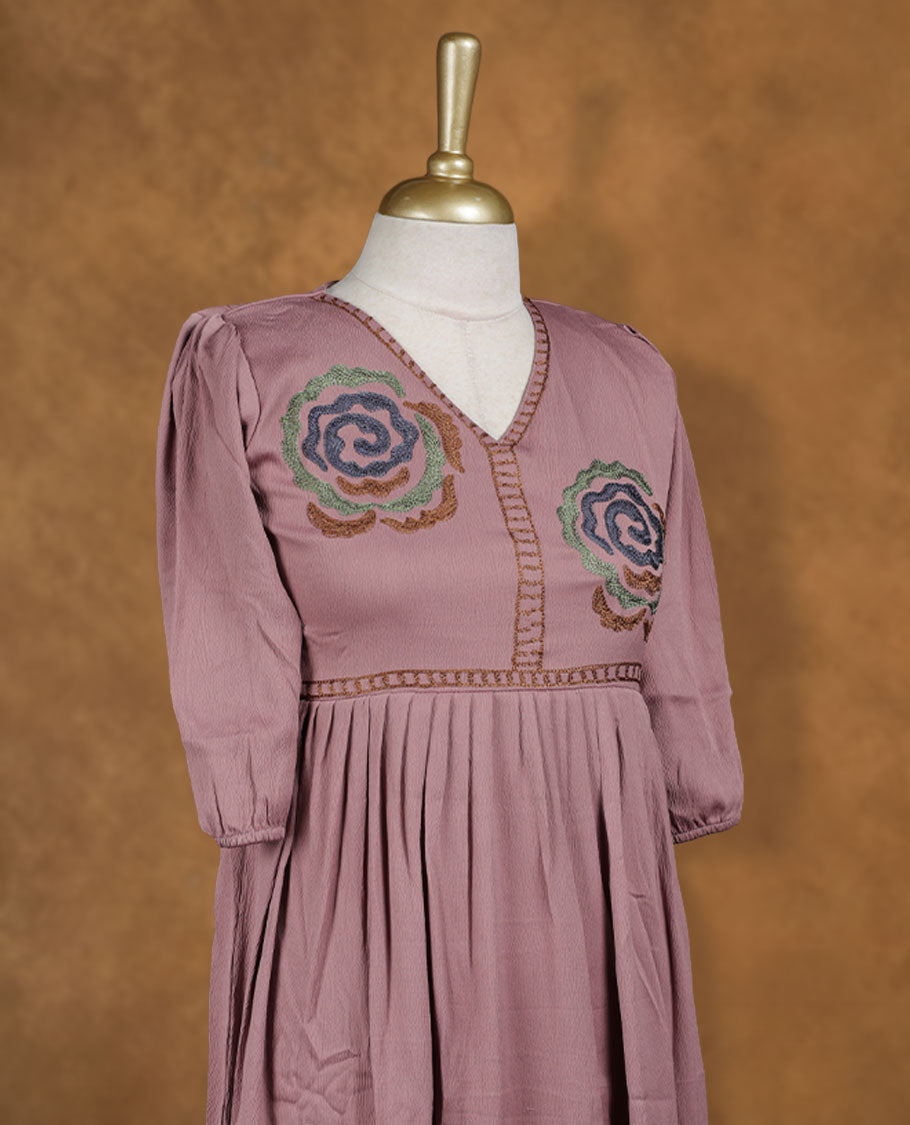 Dusty mauve knee-length A-line dress with V-neckline, multicolour spiral floral embroidery on yoke and hem, and elbow-length gathered sleeves.