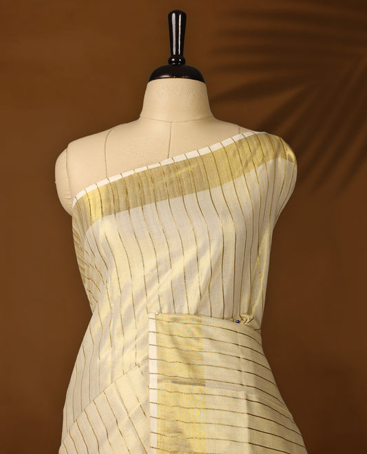 Elegant off white colour tissue Kerala saree with golden zari stripes and broad borders, Lightweight with a subtle sheen, it includes a matching blouse & perfect for weddings, rituals, and festive occasions.