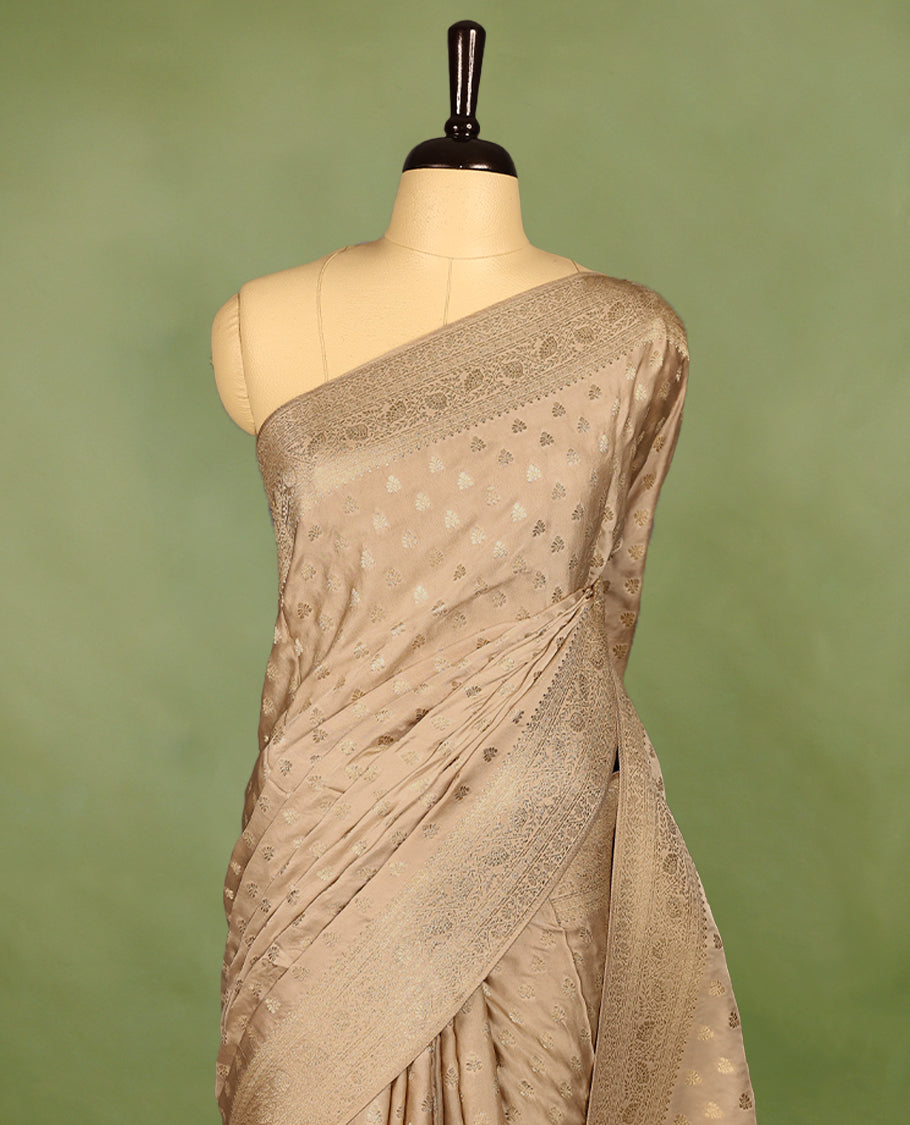 Champagne Gold semi-Banaras satin crepe saree featuring traditional closely woven buttas on the body, complemented by an antique-style border and a matching self-coloured blouse.
