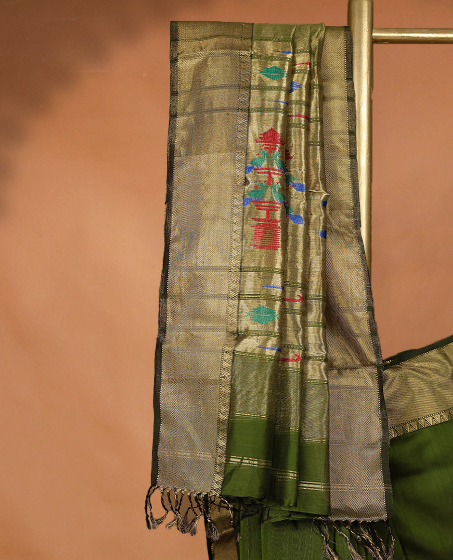 Olive Green coloured Maheshwari Cotton saree featuring antique Zari motifs across the entire body, complemented by a traditional gold coloured border and a matching blouse.