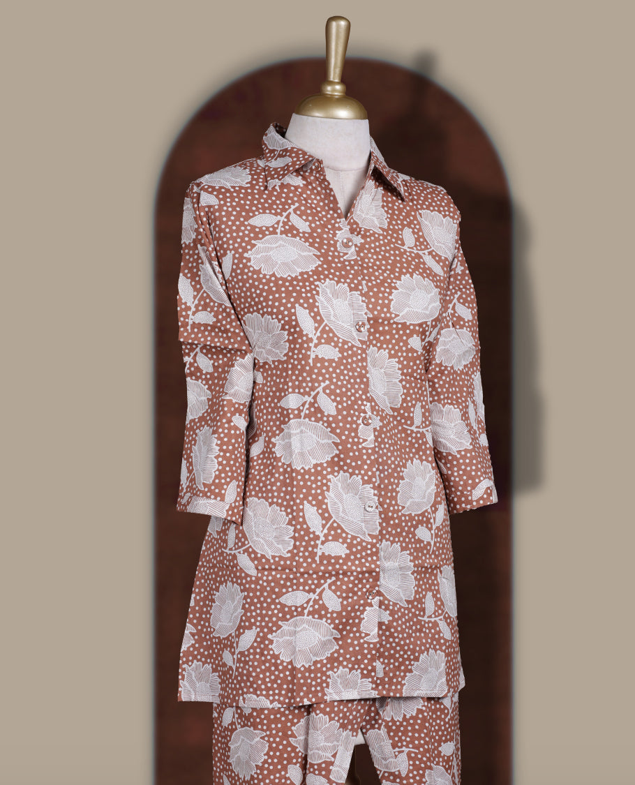 Soft brown colour cord set with bold white floral prints, Features a collared kurta with front buttons and 3/4 sleeves, paired with asymmetrical hem pants for a trendy and contemporary ethnic look.