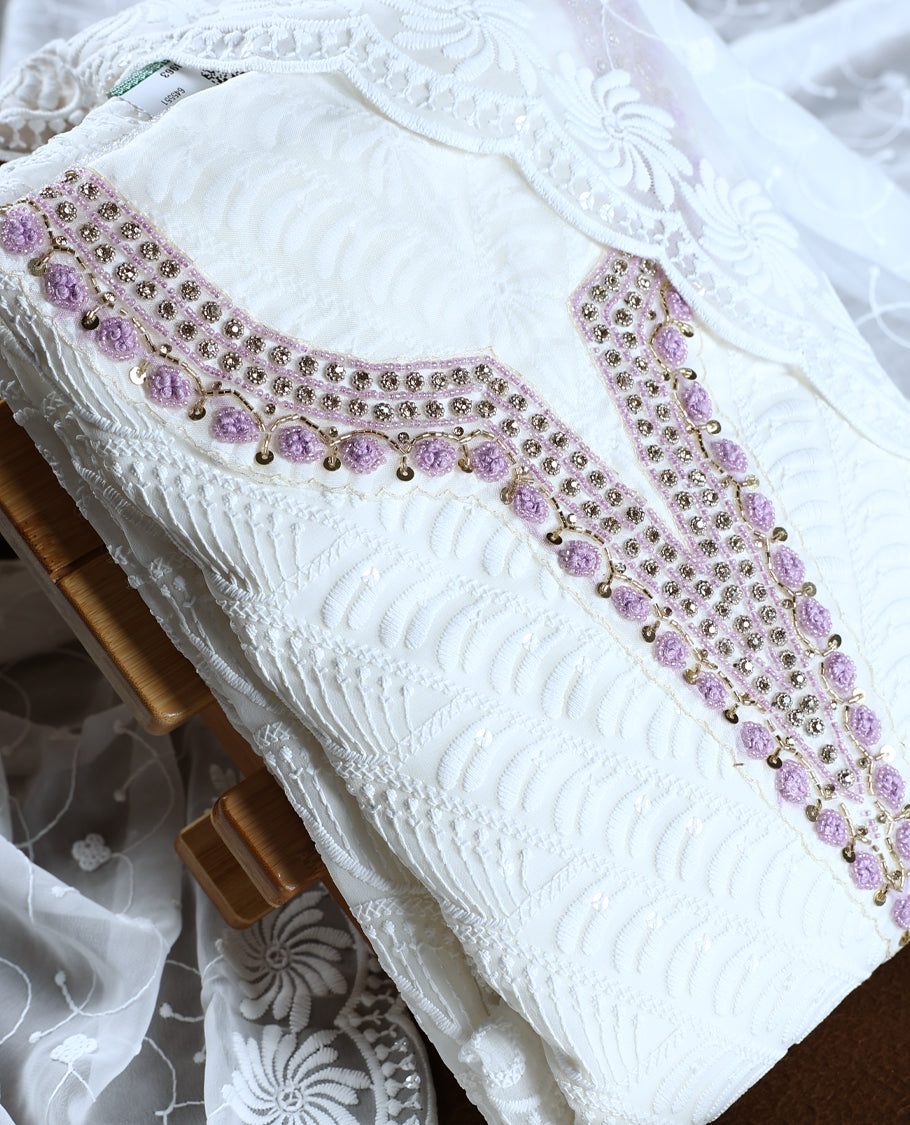 White colour churidhar material featuring delicate embroidery with violet colour sequins and bead highlights, paired with a plain white bottom & Comes with a matching embroidered net dupatta.