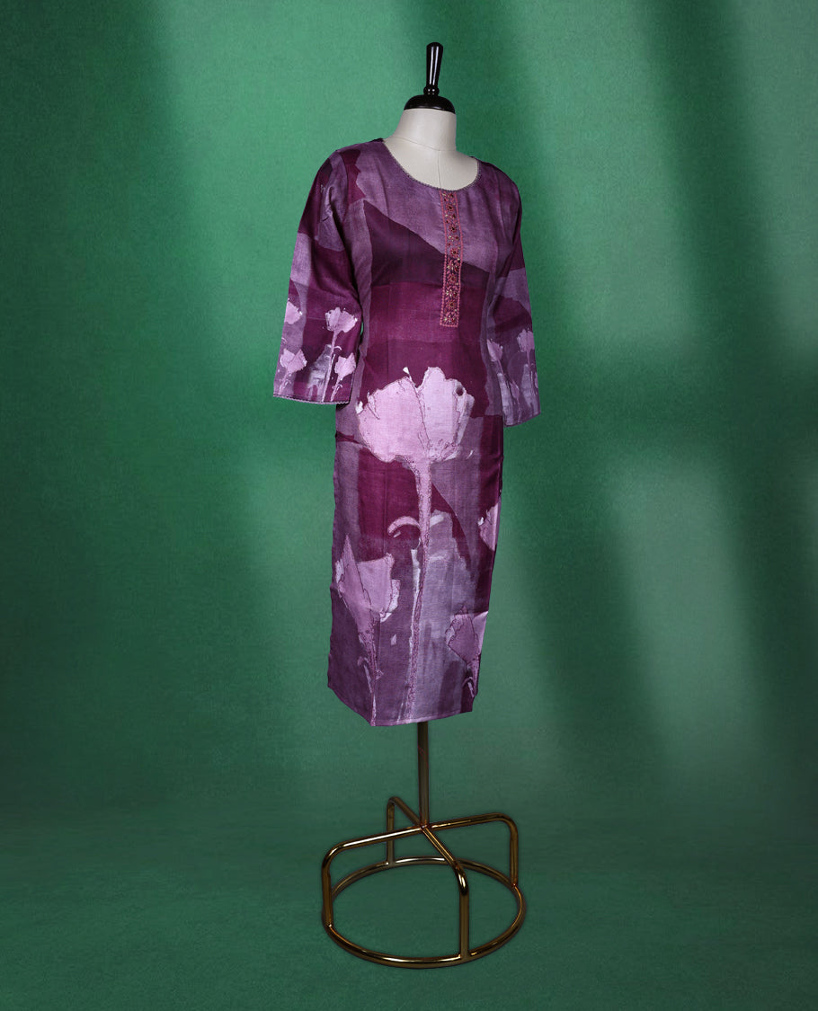 Plum purple colour kurti with a round neckline and three quarter sleeves, featuring abstract floral prints in soft lilac tones and a delicately Printed front placket for a graceful contemporary style.