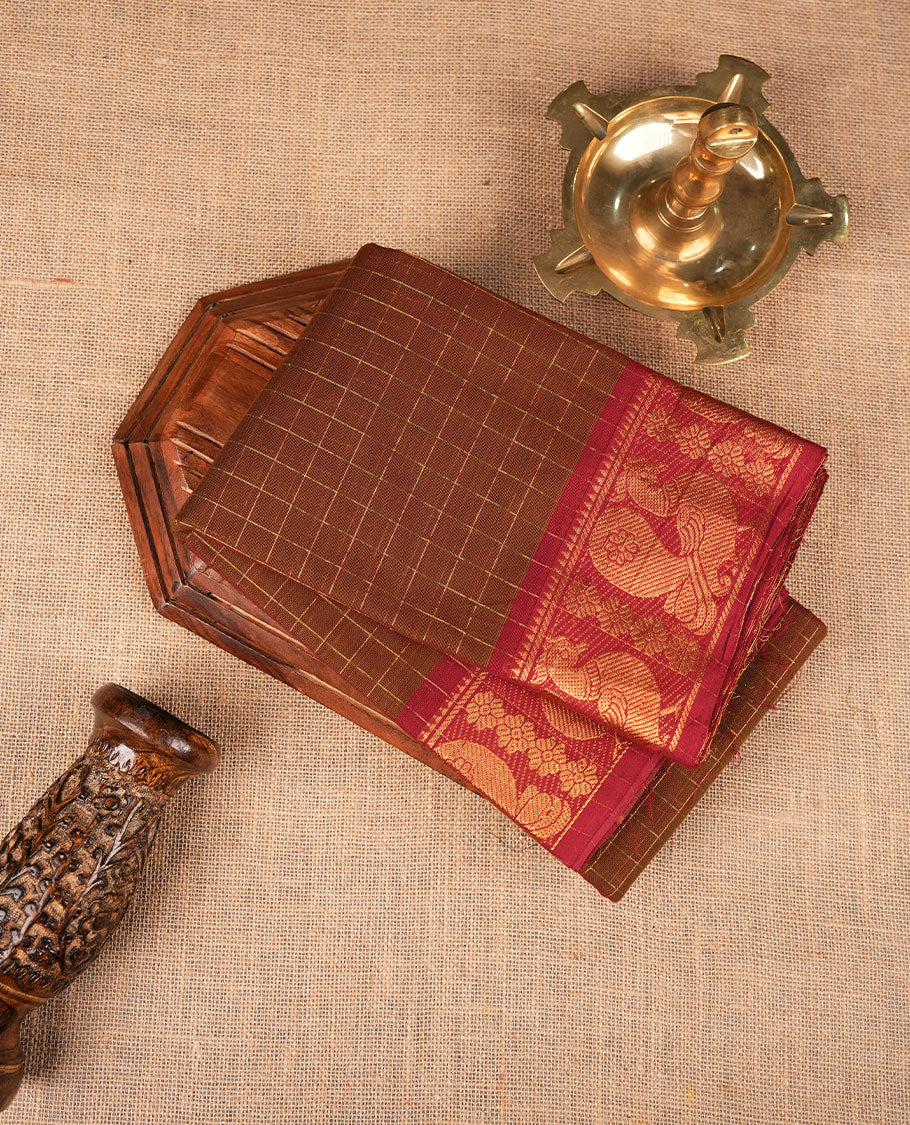 Olive brown colour sungudi cotton saree featuring gold zari check pattern across body, contrast Maroon colour with gold zari peacock and floral pattern on border, without blouse piece.