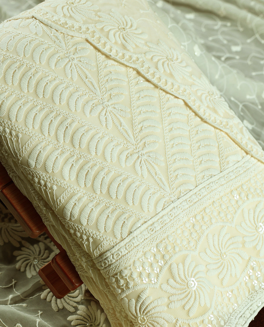 Elegant pista tinge colour churidhar material embellished with intricate floral embroidery and detailed thread patterns, paired with a plain matching bottom and embroidered dupatta, ideal for festive and elegant occasions.