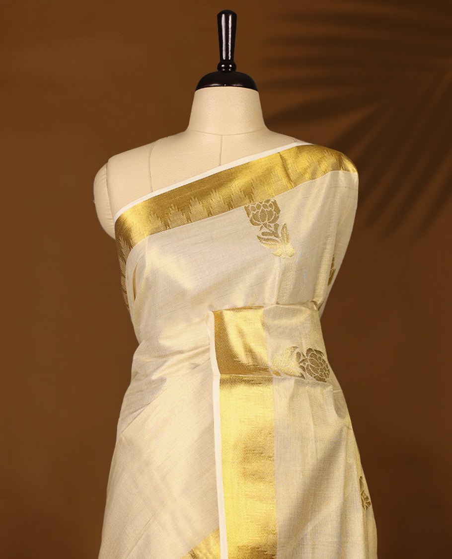Elegant Light Gold colour Tissue Kerala saree featuring Flower Motifs on body, traditional golden zari kasavu border & Rich Pallu offering a classic and graceful look, paired with a matching blouse.