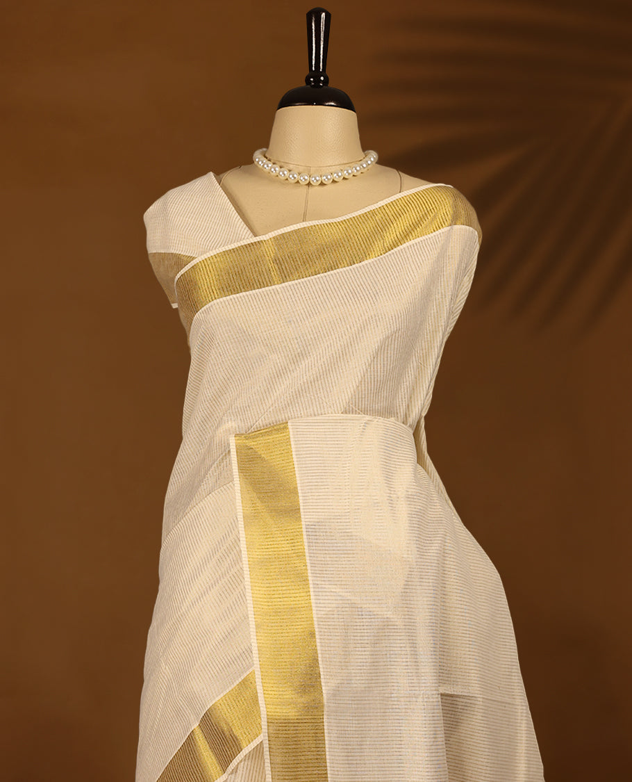 Kerala saree exudes timeless grace with its ivory base and rich golden zari border with Matching Blouse.