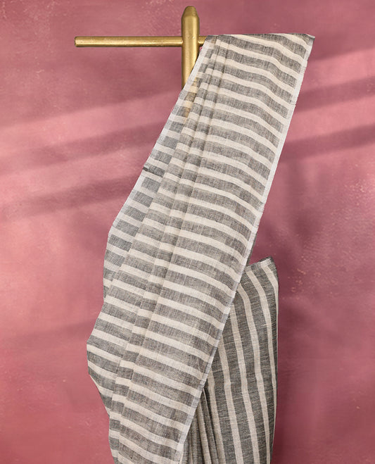 Classic grey and white colour pure linen saree with vertical and horizontal woven stripes all over the body, finished with a simple border, ideal for casual or workwear styling and pairs beautifully with a matching blouse