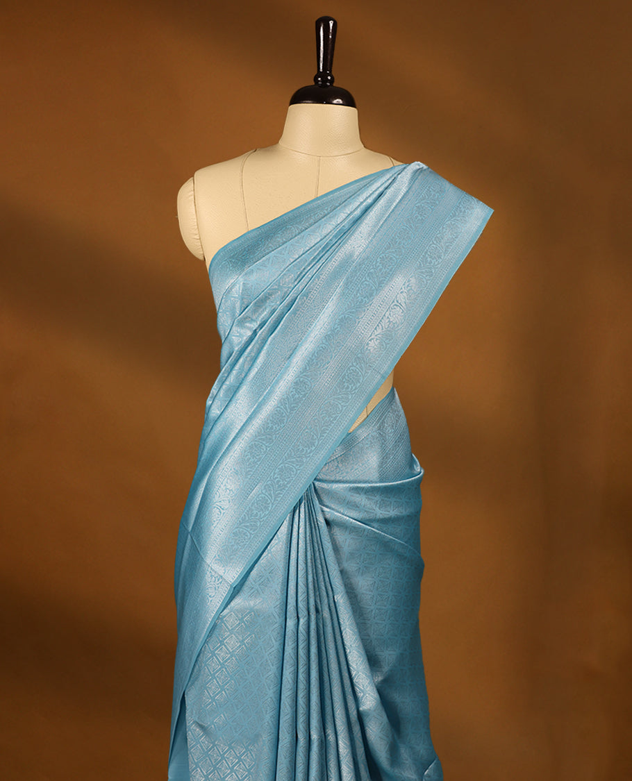 Light Blue coloured semi silk saree featuring a Silver coloured Zari Diamond design on the body, paired with a Self coloured border and matching blouse.
