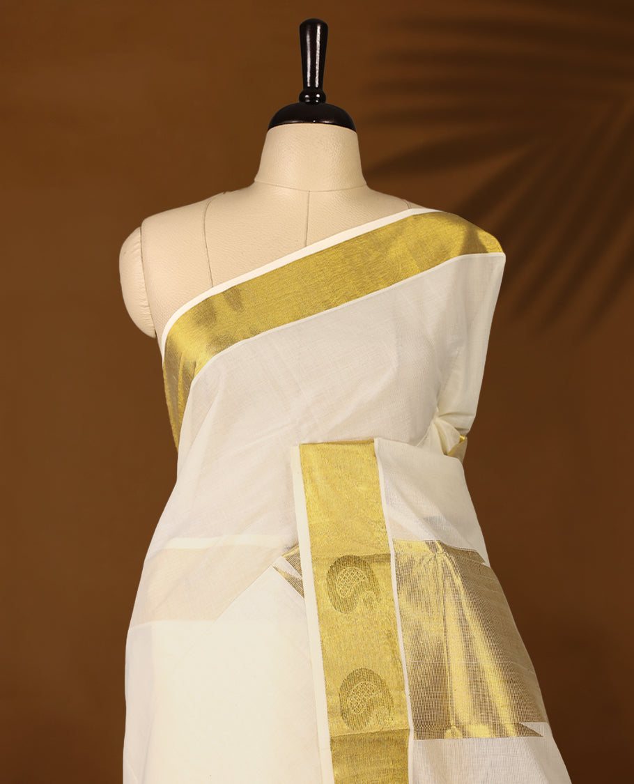 Elegant off white colour cotton Kerala saree featuring Plain body, Gold Kasavu border with Mango Motifs, rich pallu with temple motifs, Paired with matching blouse offering a classic and graceful look, paired with a matching blouse.