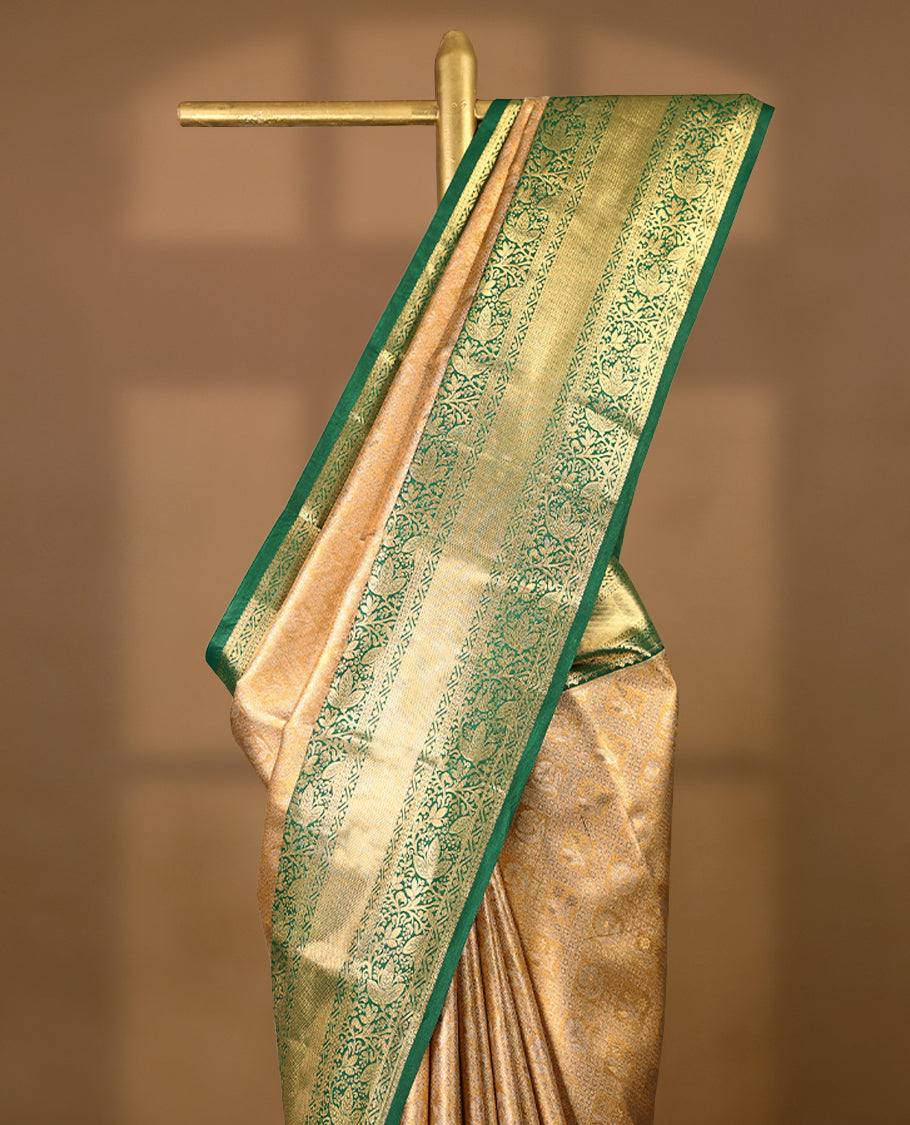 Gold colour tissue brocade saree with gold and silver zari flower and Diamond pattern on body, gold zari floral kodi work Green border, rich matching pallu with Antique zari motifs, paired with matching blouse.