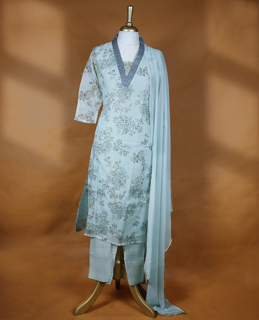 Baby blue colour salwar from TWARA, featuring a V-neck adorned with sequins and thread work, with floral prints on the top, paired with a matching bottom and dupatta.