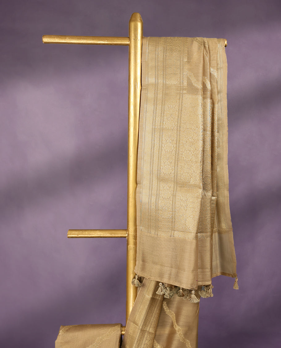 Beige colour pure Banarasi Chanderi cotton, beautifully adorned with traditional antique zari Cross Kodi designs across the body, completed with a hand-dyed colour, a traditional border, and a matching blouse.