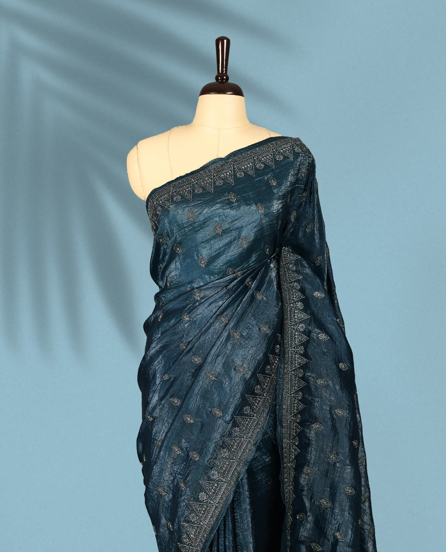 Midnight Blue Colour crush soft silk saree, textured body with a natural crinkled finish, adorned with intricate Silver colored floral Motifs and complemented by a delicate Silver Zari embroidery border, paired with a matching blouse