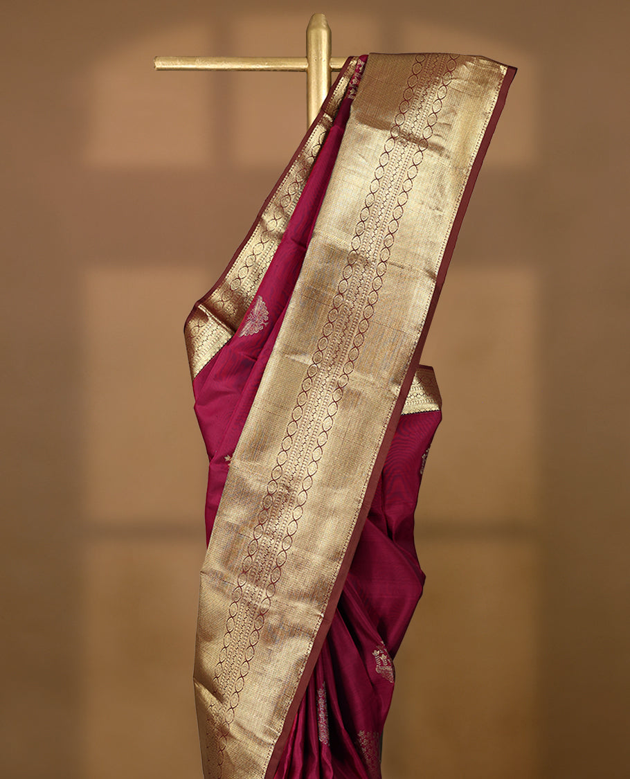 Mulberry coloured pure traditional Kancheepuram silk saree featuring antique zari floral motifs, complemented by a traditional self coloured border and a matching blouse.