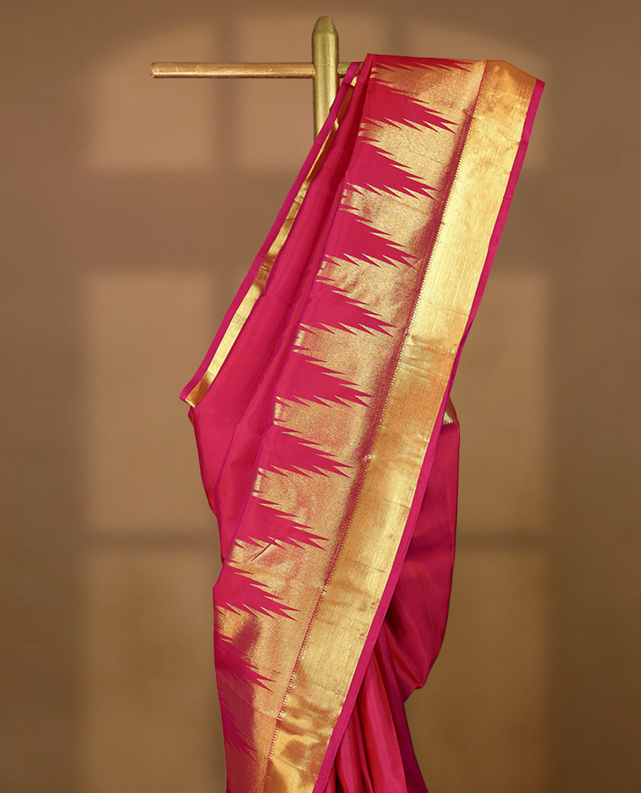 Pink traditional Kancheepuram silk saree featuring Plain body, a coordinated Traditional Temple design on the border, and a matching blouse.