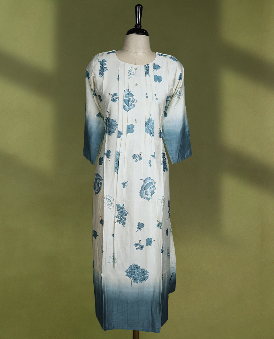Off-white colour cotton kurti with blue floral prints, ombre dyed three quarter sleeves and hem, featuring a round neckline with a slight slit and front pintuck detailing