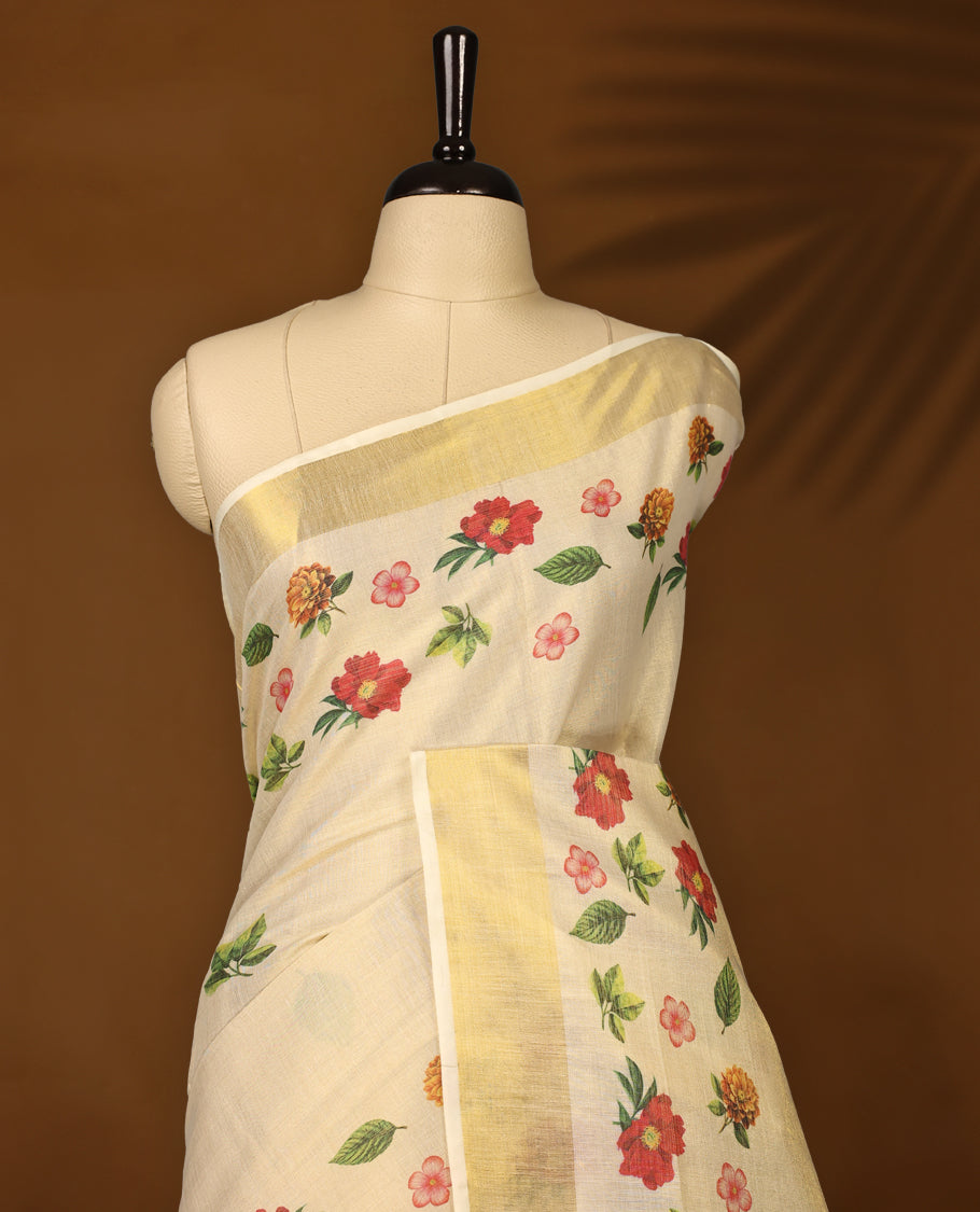Elegant off white colour tissue Kerala saree with vibrant floral prints and a shimmering golden zari border, Lightweight and graceful, perfect for festive or traditional occasions & Includes matching blouse piece.