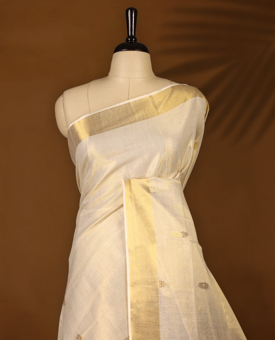Elegant Light Gold colour Tissue Kerala saree featuring gold zari motifs on body, traditional golden zari kasavu border & Rich Pallu offering a classic and graceful look, paired with a matching blouse.