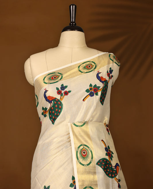 Elegant off-white Kerala cotton saree with vibrant peacock digital prints and a rich golden zari border. Perfect for festive and traditional occasions. Comes with a matching blouse piece.