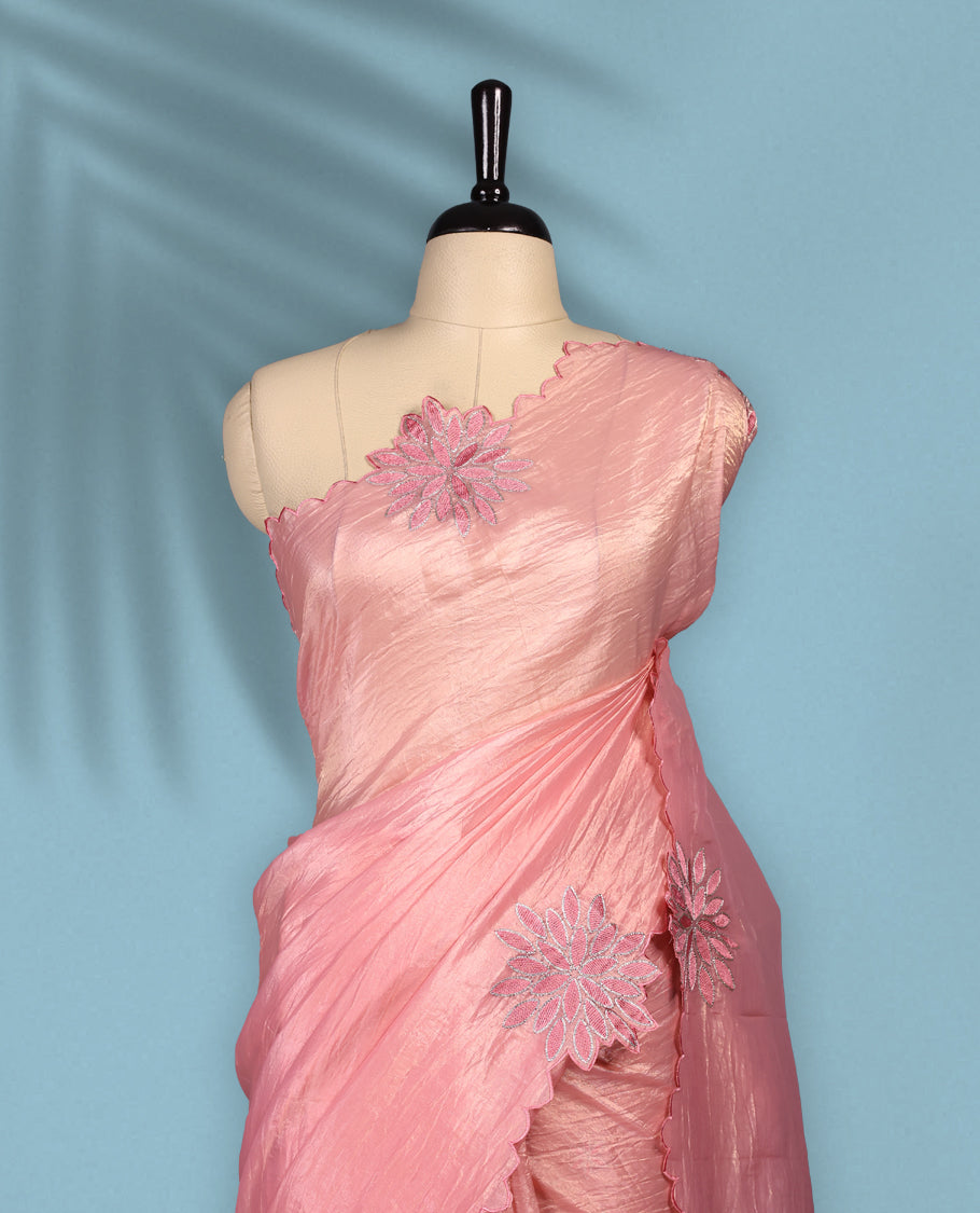 Peach colour crush soft silk saree adorned with bold floral thread embroidery on the body and scallop edged borders, Paired with a matching blouse for a complete look.