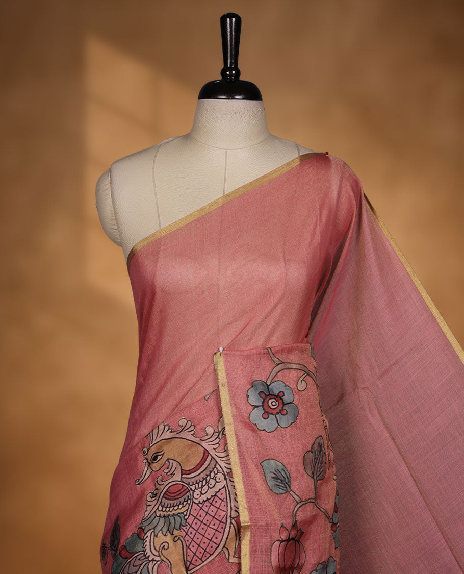 Georgia peach colour colour semi linen saree featuring hand-painted bird and floral motifs on the body, finished with a subtle gold border and paired with a matching floral print blouse.