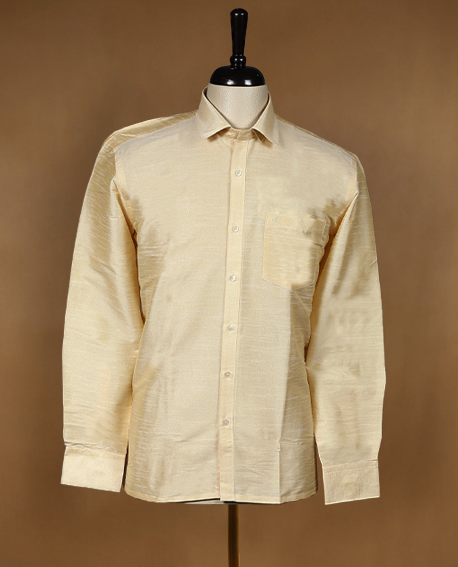 Golden beige DH men’s shirt featuring a glossy silk finish with self textured weave, full sleeves, classic collar, and chest pocket ideal for weddings and traditional functions