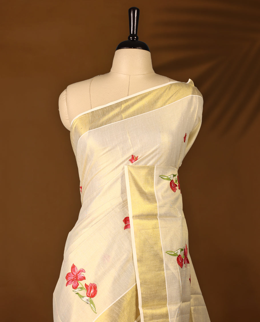 Light Gold colour Tissue Kerala saree featuring Flower Embroidery body and a beautifully woven Gold Kasavu border with Red & Pink colour Floral embroidery work, paired with a matching blouse perfect for festive occasions.