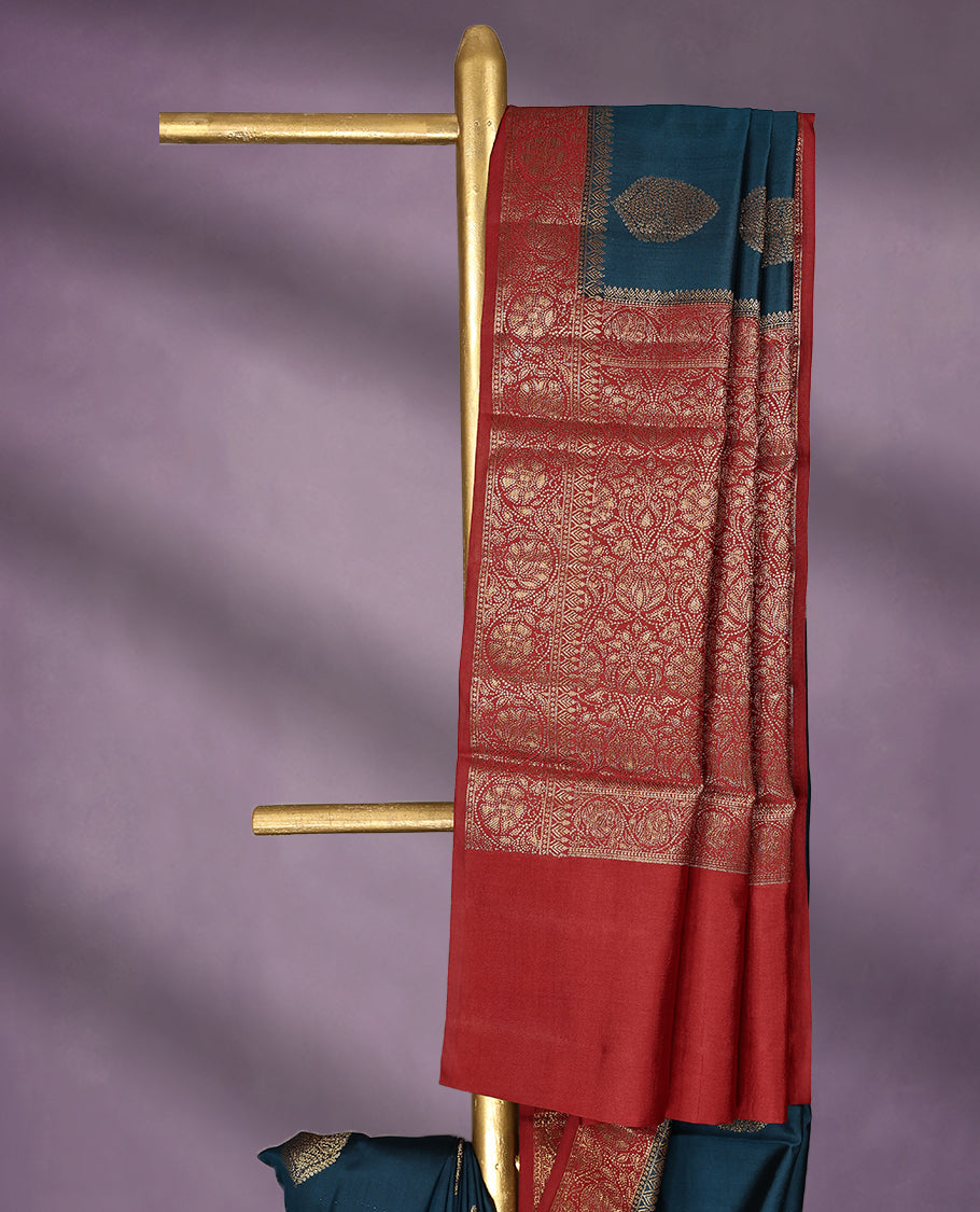 Greman Blue Colour Pure Banaras Soft Silk Saree adorned with traditional antique zari motifs, paired with a hand dyed Chilly Red antique style border and a matching blouse.