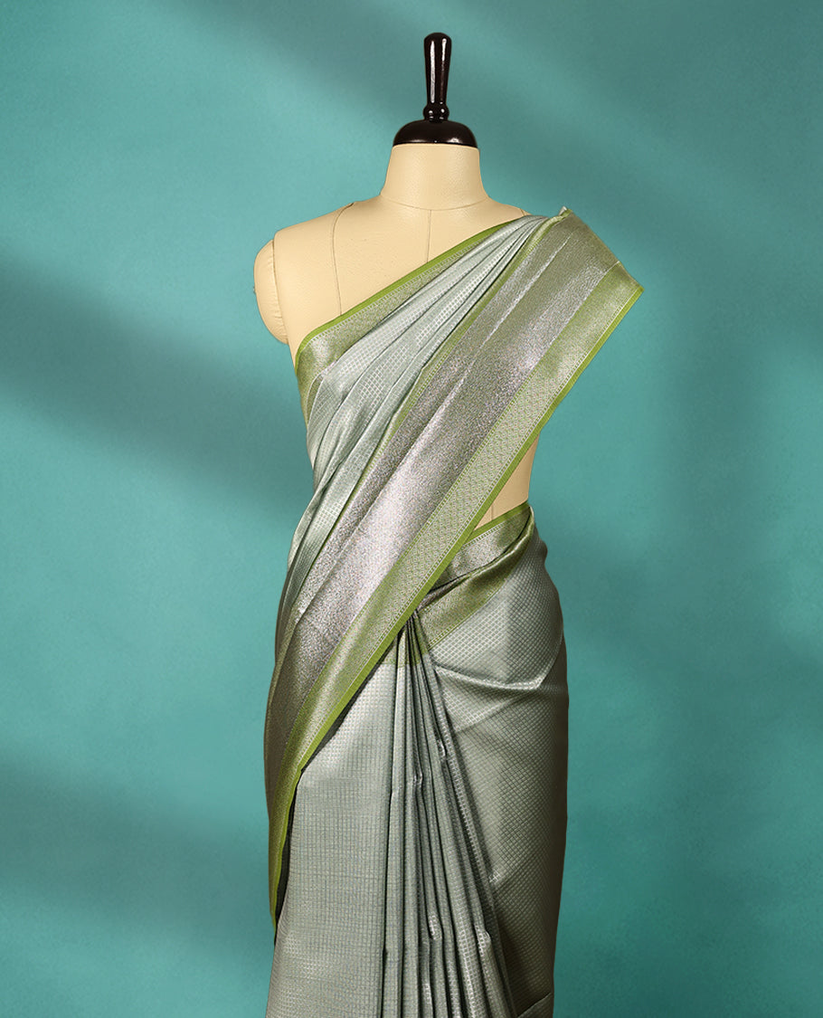Greenish Grey coloured Art Soft Silk saree featuring a Check design on the body, paired with a Green coloured border and matching blouse.