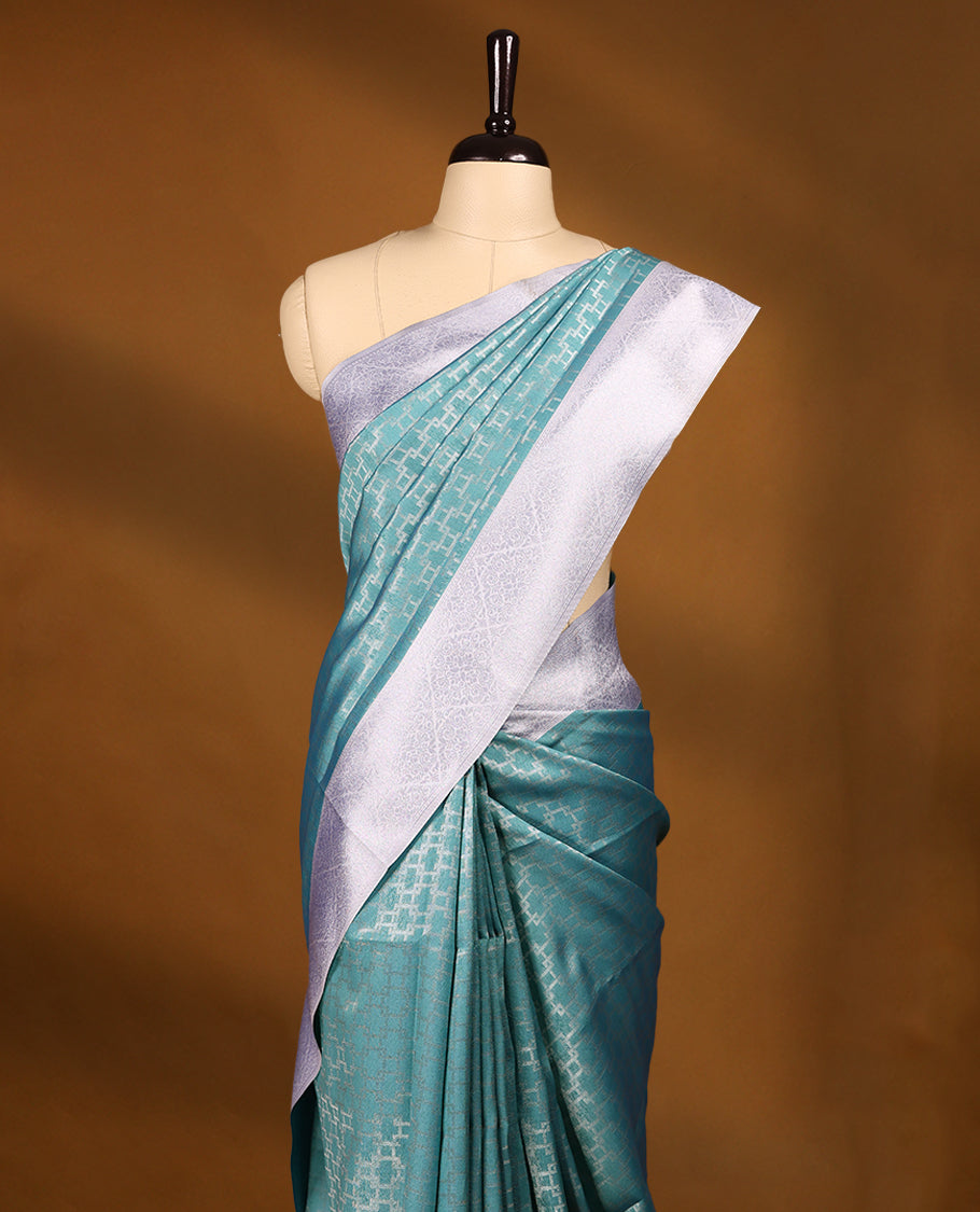 Aqua Green coloured semi silk saree featuring a Silver coloured Zari design on the body, paired with a Baby Blue coloured border and matching blouse.