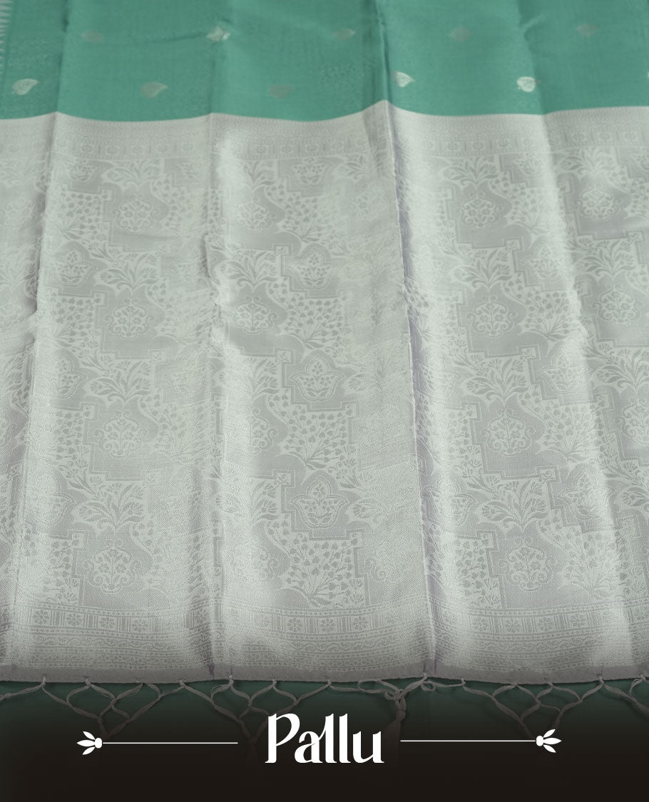 Sea Green colour Semi Silk Saree with Subtle Zari Butta Motifs on the Body, Contrasting Silver Zari Woven Pallu and Border with Intricate Patterns and Tassels, Paired with Coordinated Blouse Piece