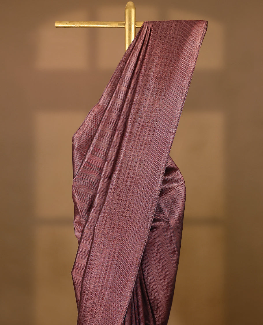 Maroon Colour Manthrakodi saree featuring an antique zari brocade body, complemented by a traditional Jada Naagam brocade border and a matching brocade blouse.