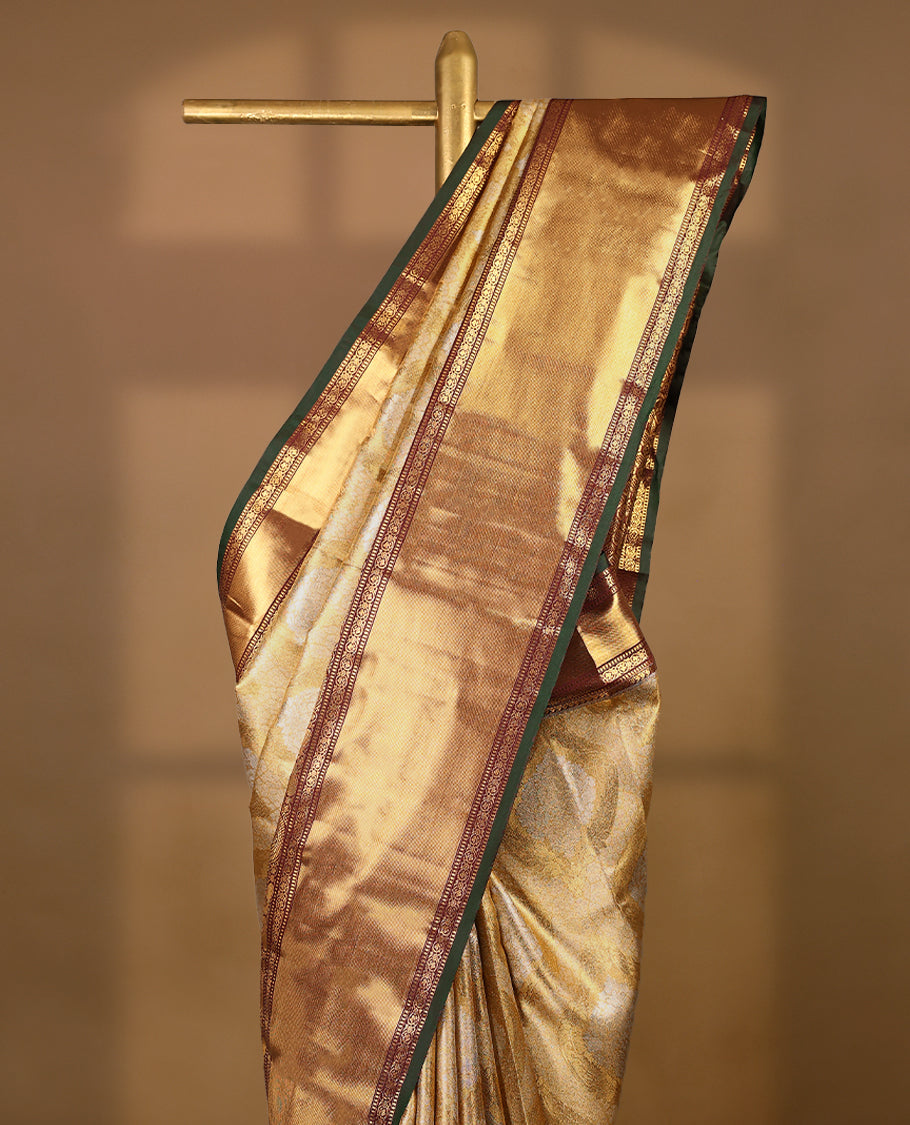 Gold colour tissue brocade saree with gold and silver zari Bold pattern on body, gold zari traditional mango and peacock work brown & green border, rich matching pallu with Antique zari motifs, paired with matching blouse.