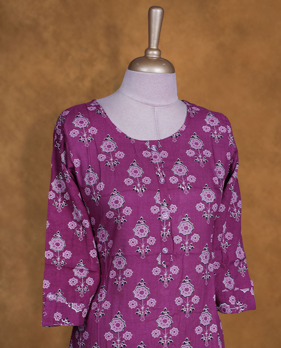 Purple colour kurti with white & black floral prints, knee length design, styled with a round neckline and a 3/4 sleeve .