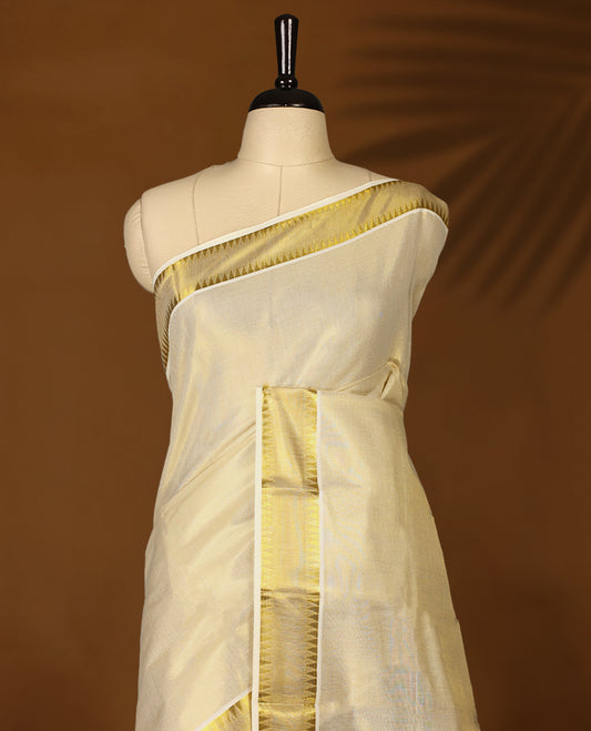 Elegant Light Gold colour Tissue Kerala saree featuring Plain body and traditional golden zari kasavu border, Rich pallu offering a classic and graceful look, paired with a matching blouse.