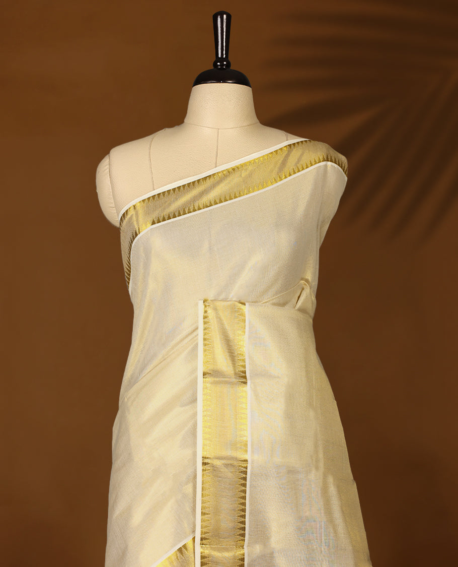 Elegant Light Gold colour Tissue Kerala saree featuring Plain body and traditional golden zari kasavu border, Rich pallu offering a classic and graceful look, paired with a matching blouse.