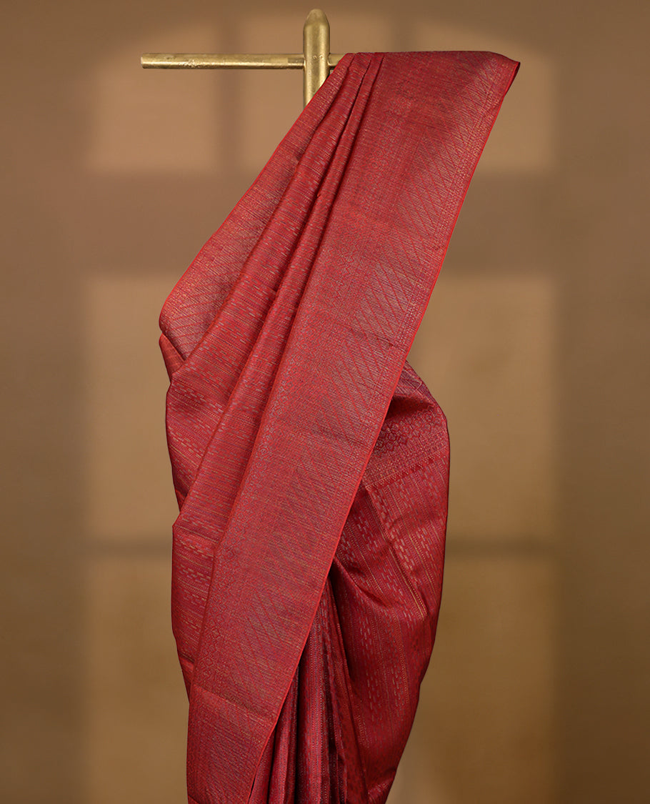 Red coloured Manthrakodi saree featuring a multicoloured zari jacquard body, complemented by a self coloured turning Banarasi border and a matching self coloured blouse.