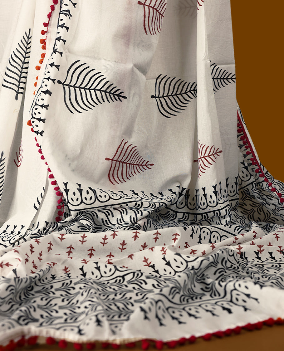 White cotton saree with black handblock prints, a detailed border enhanced with a combination of pink and orange piping, and with contrast blouse.