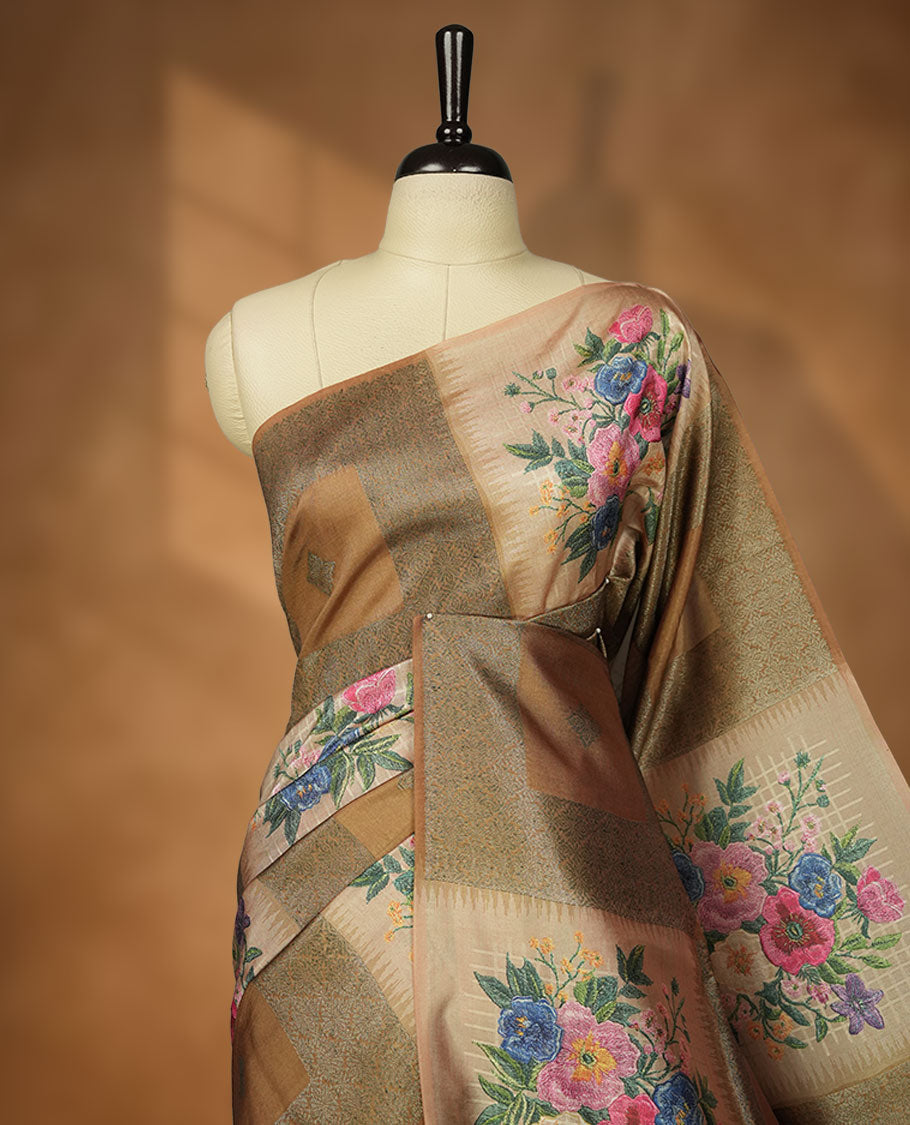 Dark Yellow color semi tussar Banarasi saree featuring vibrant multi-color floral prints across the body, with geometric zari patterns, and a matching blouse detailed with silver woven buttas.